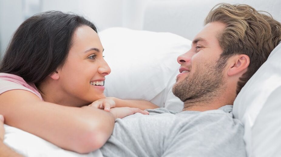 Happy woman and man in bed